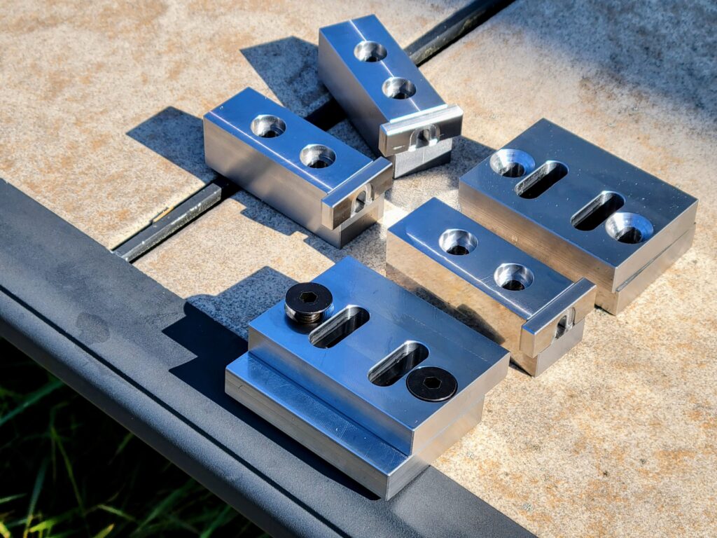 Finished products made from 4140 prehard steel sitting on a table outside.