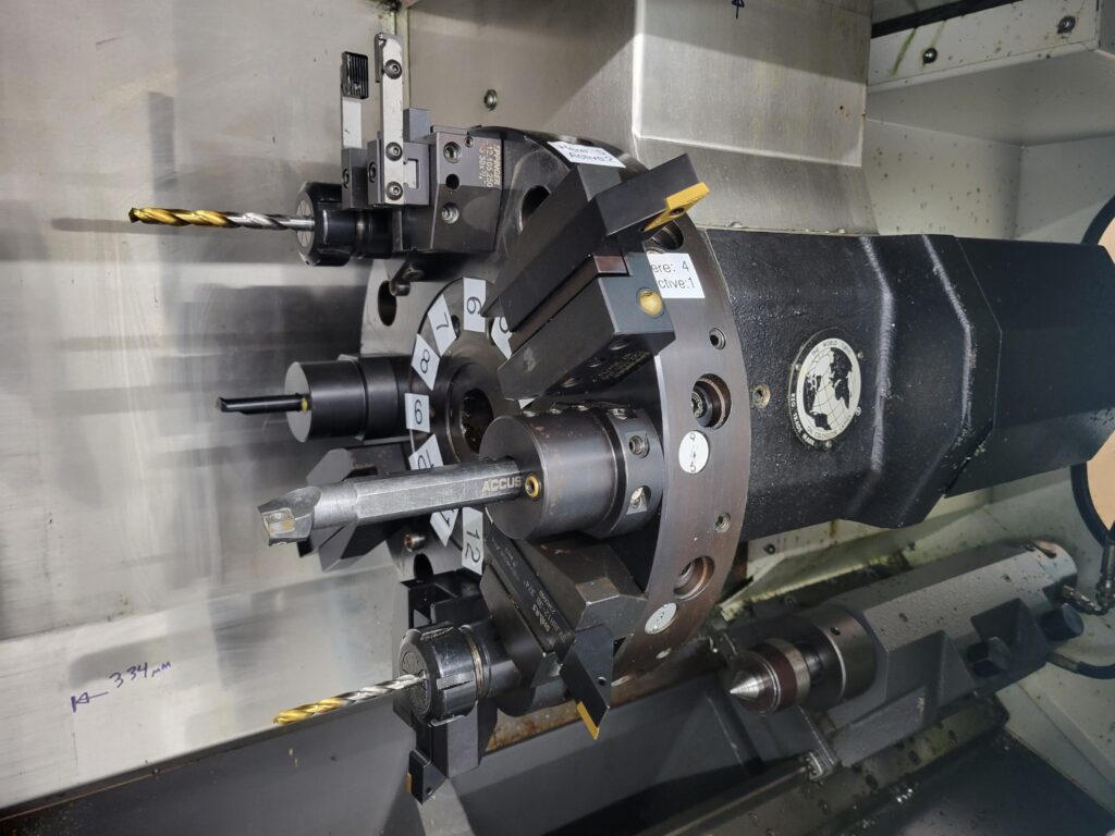 Turret lathe interior showing a plurality of cutting tools.