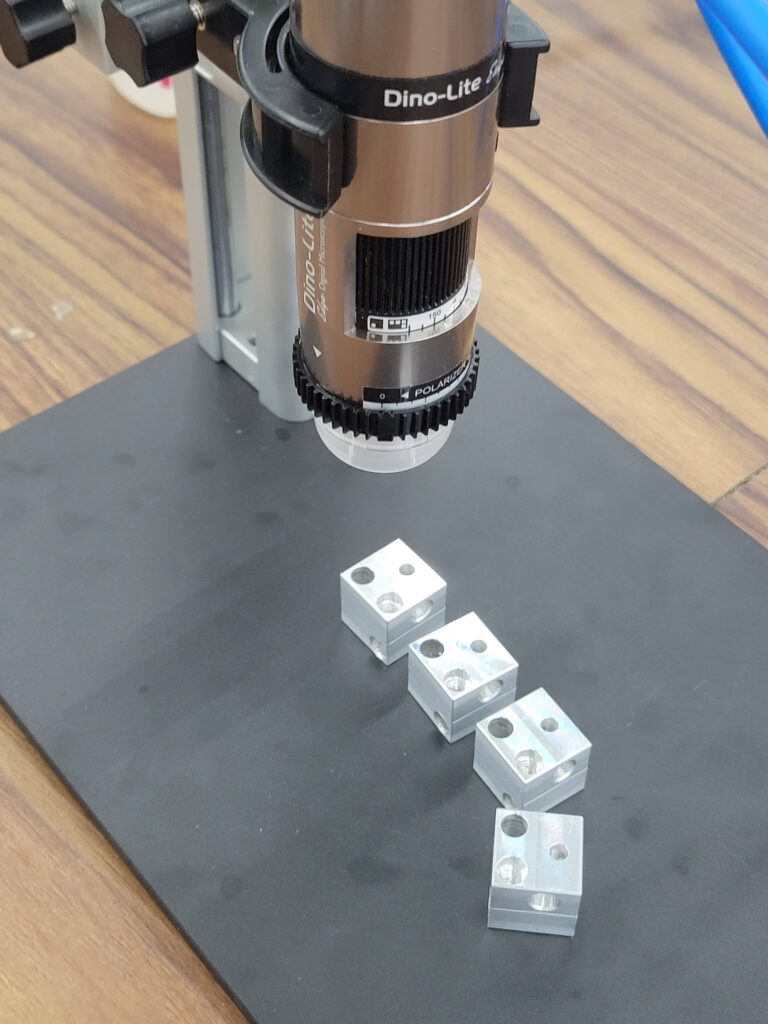 Dino lite microscope with some aluminum blocks in view.